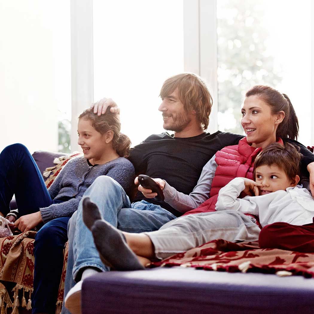 Family sitting on sofa