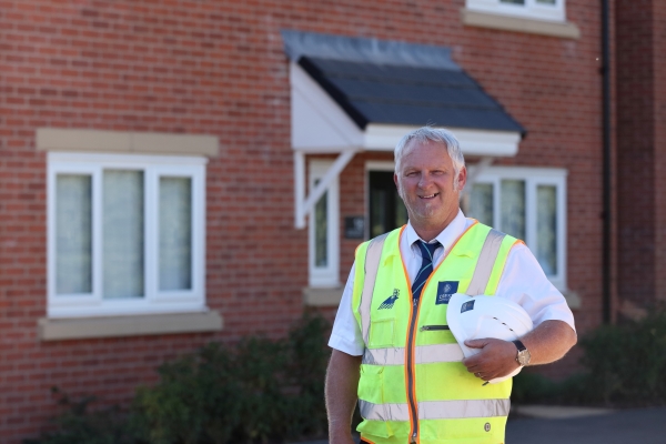 Mick Wale standing outside a house at Sketchley Gardens