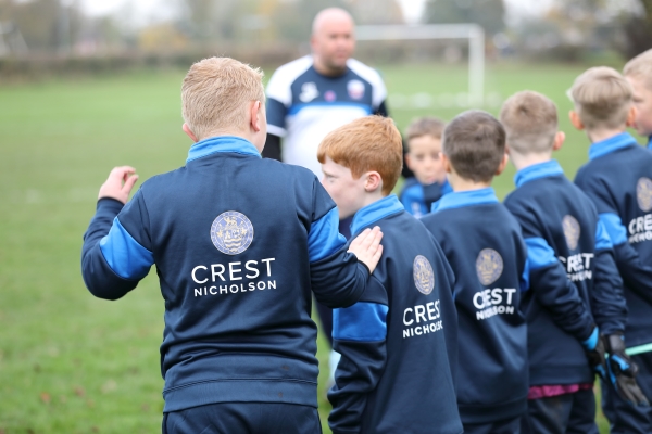 Four boys with Crest Nicholson tracksuits